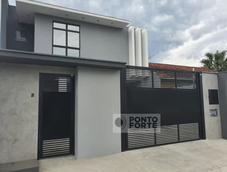 Portão de garagem de alumínio preto vazado e porta social preta separada, em vão próprio na fachada